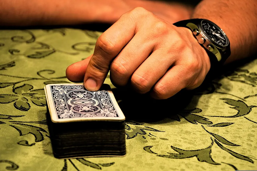 Playing cards fanned on a table, weighing the odds of a CS2 handicap bet