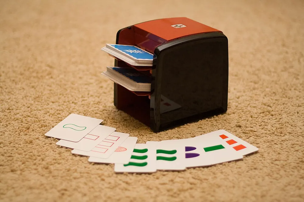 Vintage card shuffler with a deck of cards