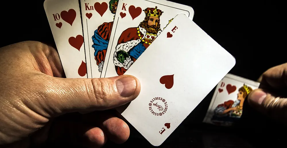 Hand holding a pair of playing cards