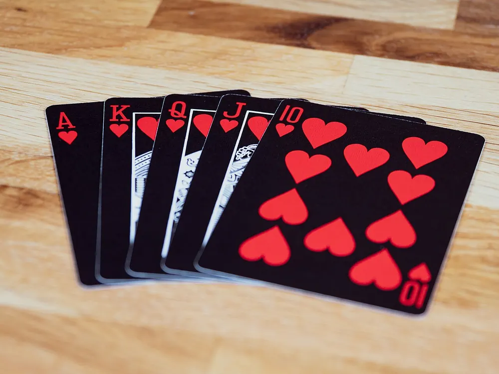 Spread of playing cards on a red background, looking at CSGOEmpire alternatives