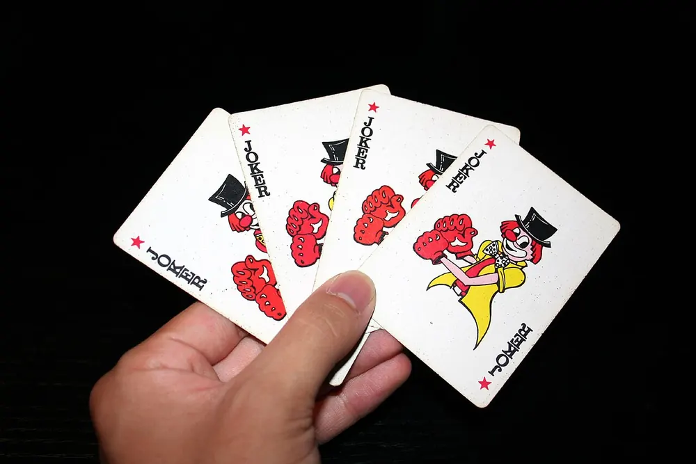 Hand holding a spread of playing cards, waiting on a Clash.gg withdrawal