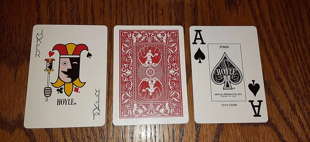 Ace of spades and a face-down card on a wooden table, the ID check behind Clash.gg KYC