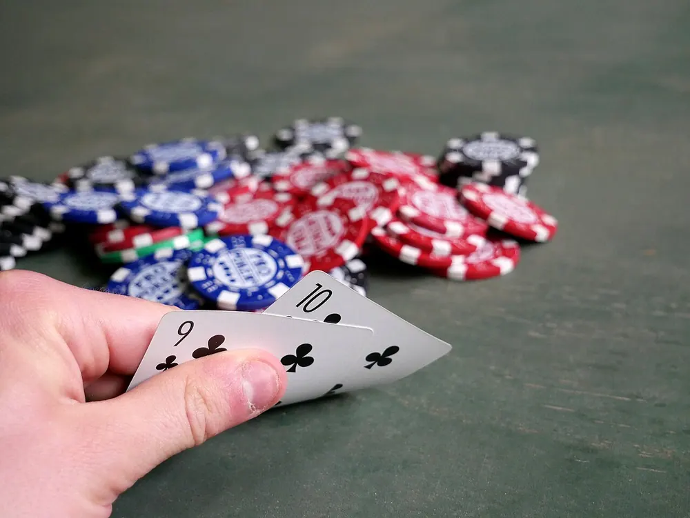 Two poker cards resting on stacks of poker chips, fair odds in action
