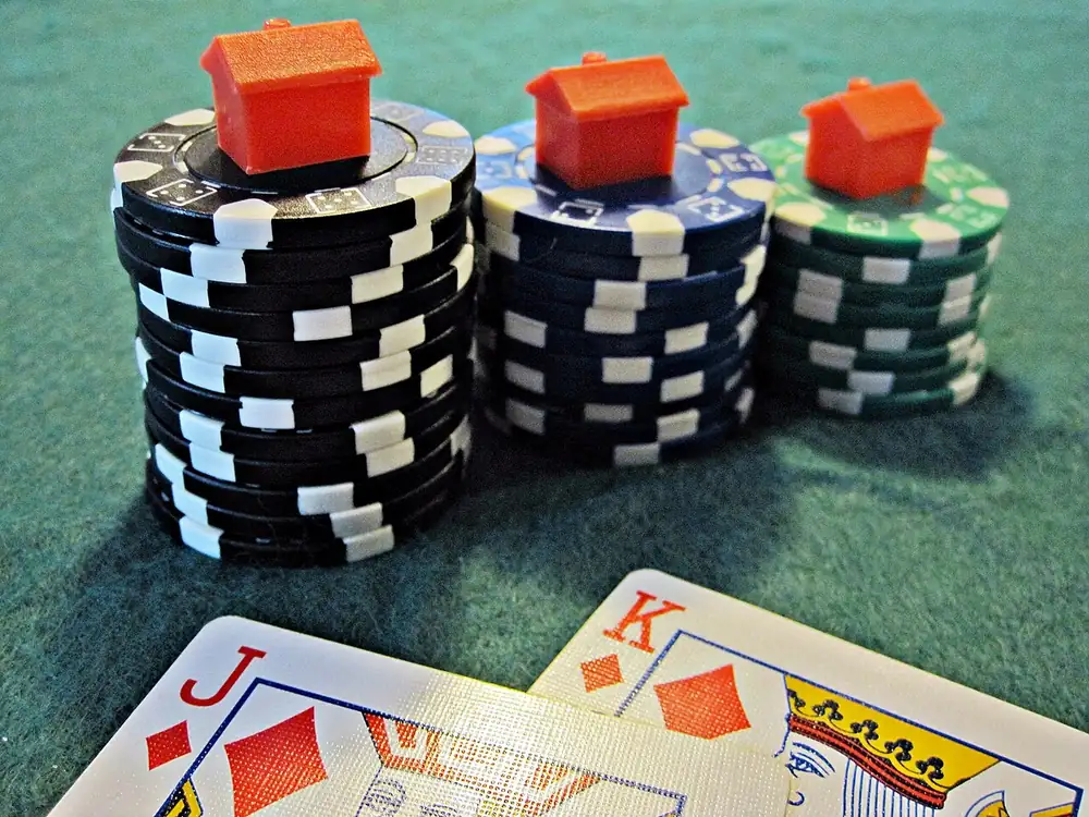 Poker chips stacked beside a game board, browsing Clash.gg alternatives