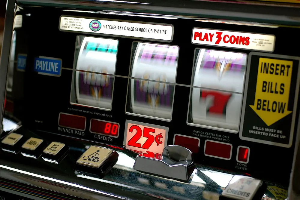 Row of slot machines lit up, how CS2 gambling sites work on chance