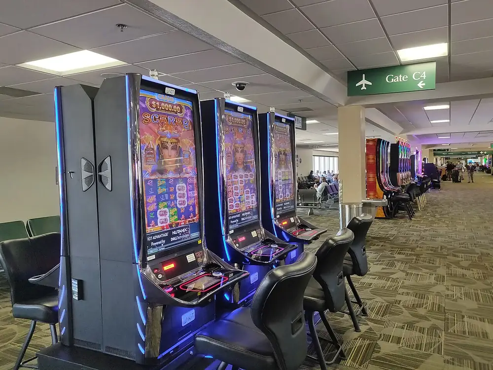 Row of slot machines in an airport lounge