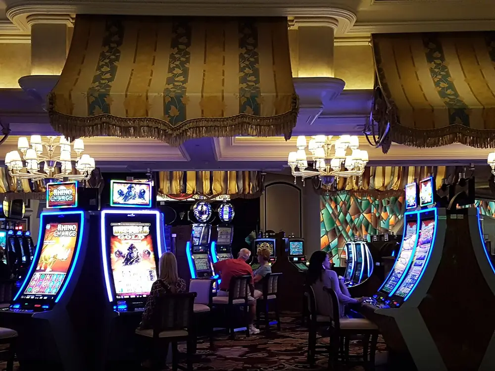 Rows of slot machines on a casino floor, a drop like plinko