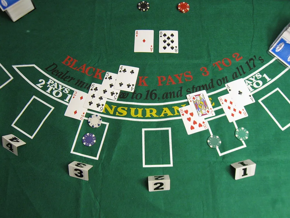 Blackjack cards and chips on a casino table