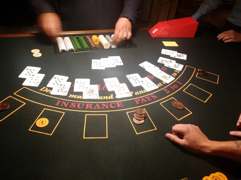 Dealer handing out cards on a blurry blackjack table