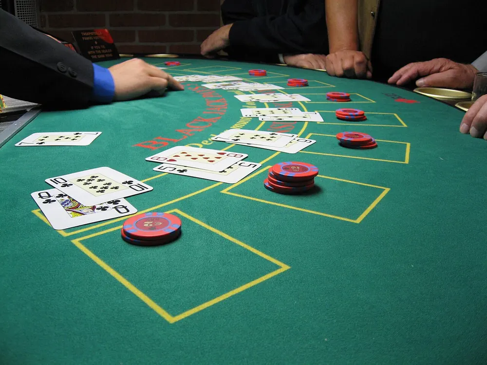 Blackjack table felt with chips and cards
