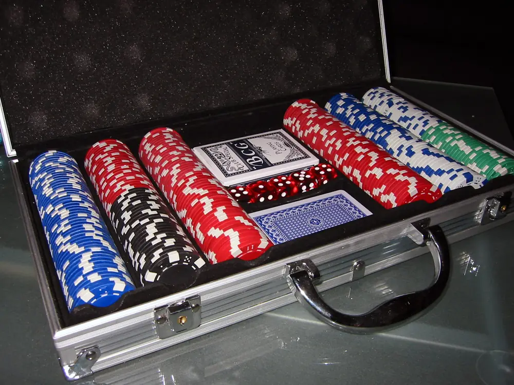 Poker chip set in an open aluminum case with cards