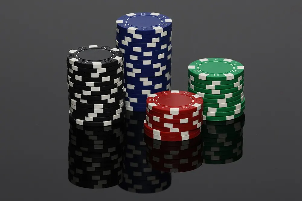 Tall stacks of poker chips on a dark table