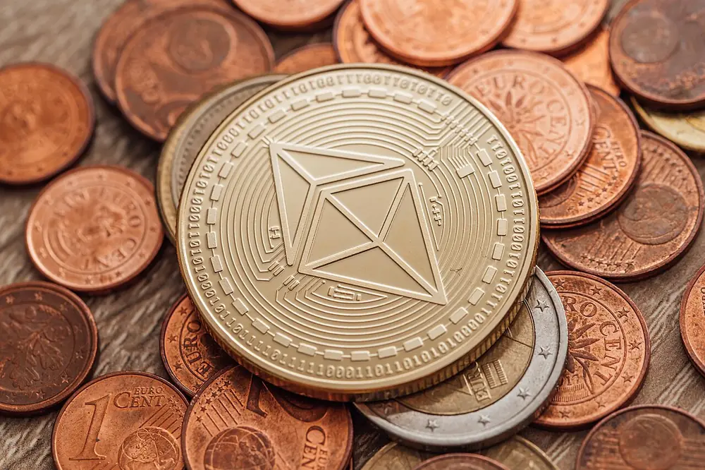 Ethereum coin on a pile of copper coins, the inputs and payout of a trade-up contract
