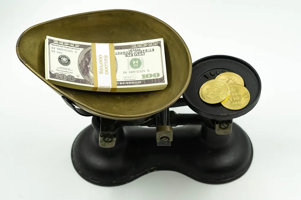 Old balance scale holding cash and coins