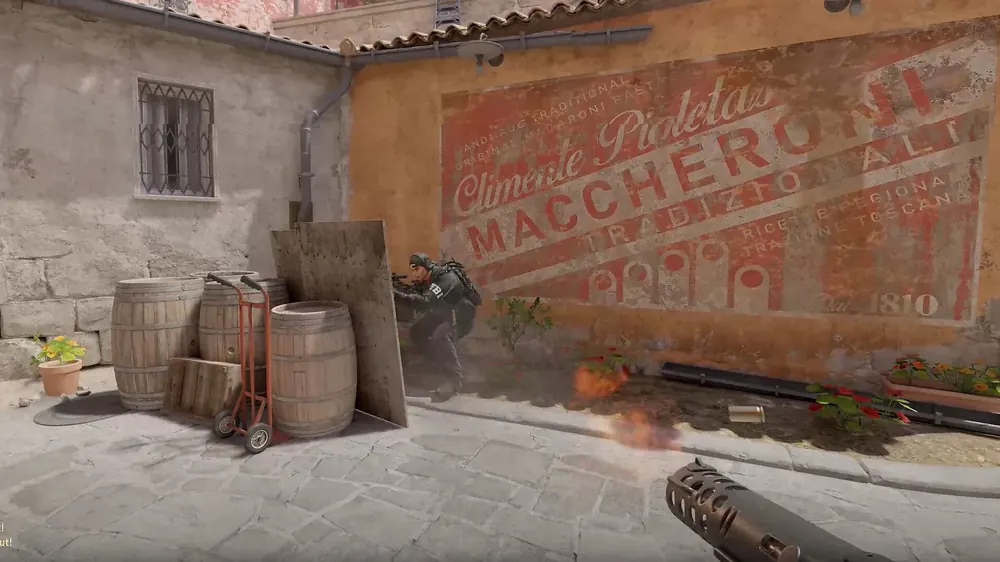 Counter-Strike 2 screenshot of a market alley with a pasta mural and barrels, for this guide on cs2 trade bots explained