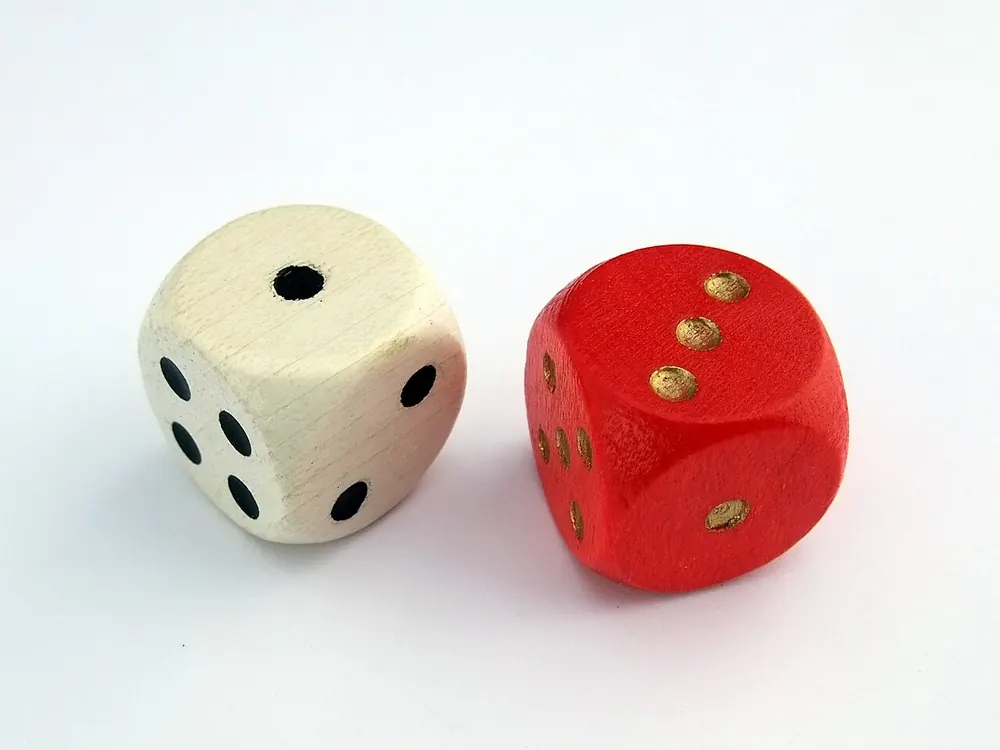 Pair of red dice on a dark surface