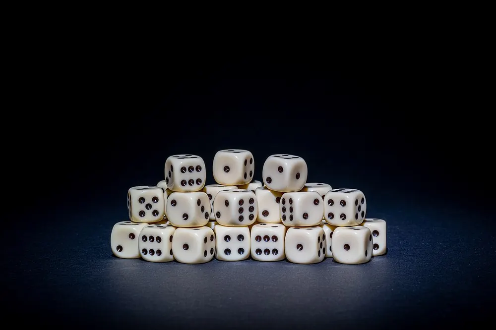 Several white six-sided dice, a 50/50 feel like a coinflip