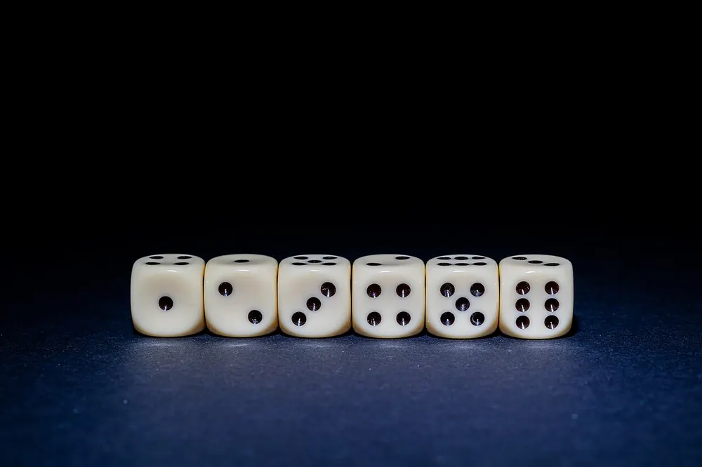 Six-sided white dice scattered on a table