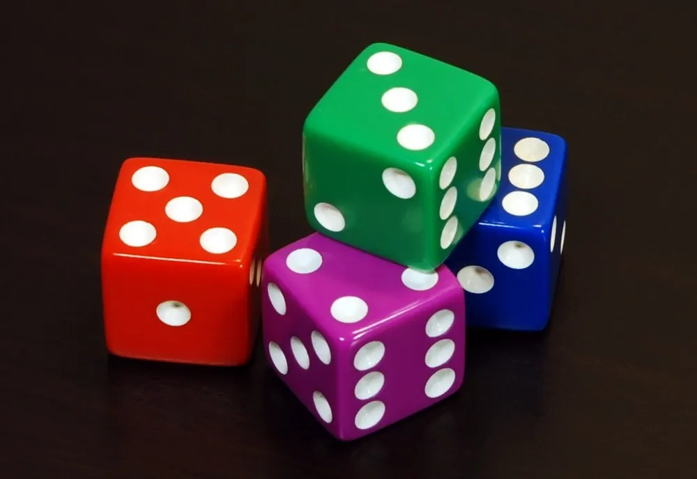 Four colored six-sided dice arranged in a row, chasing the jackpot