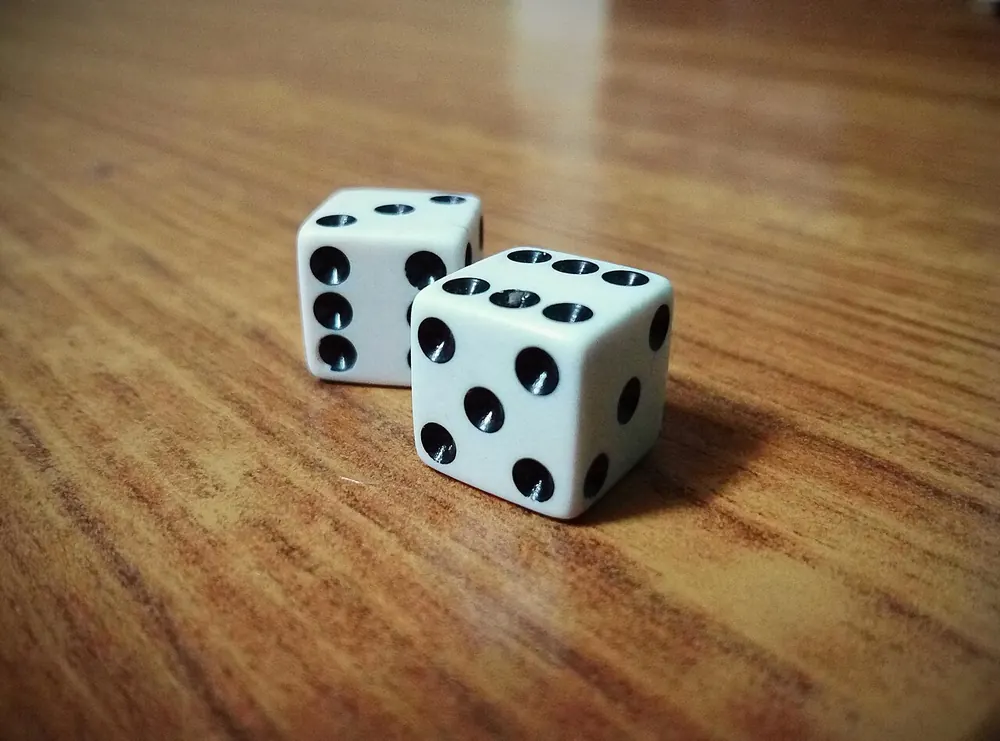 Pair of dice on a table showing six and five