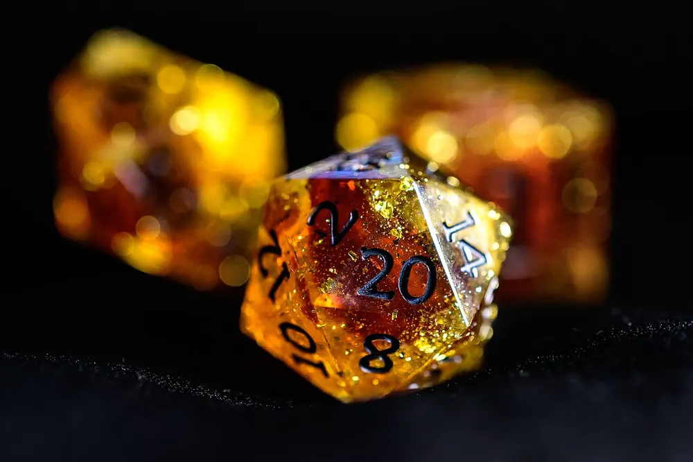 Resin polyhedral dice glowing in warm light