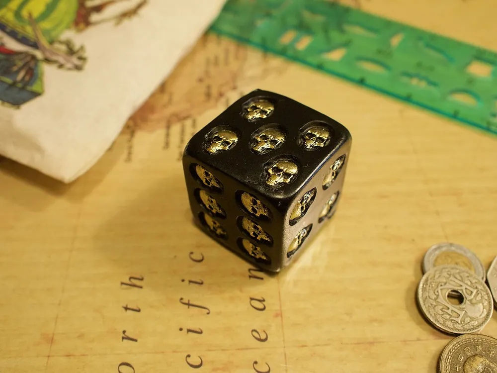 Skull die resting on a map