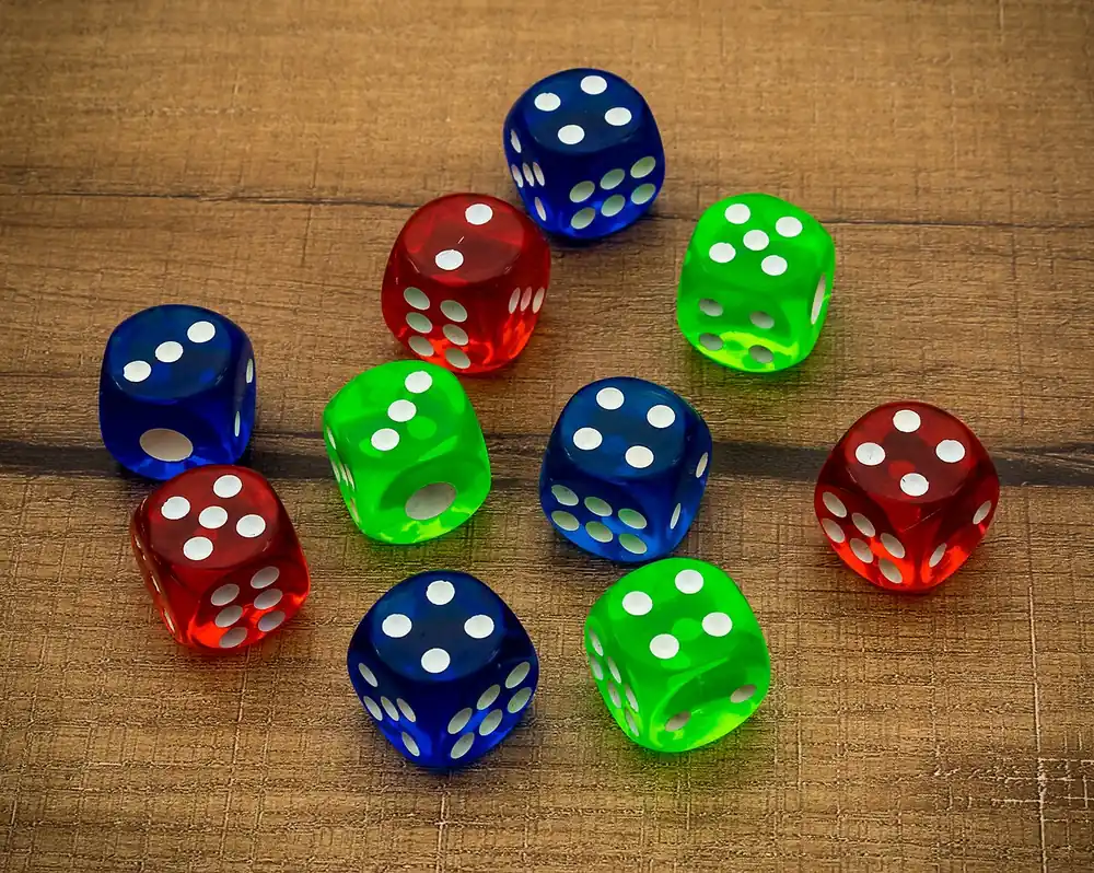 Colorful dice scattered on a white table, a question of whether Clash.gg is legal in the US