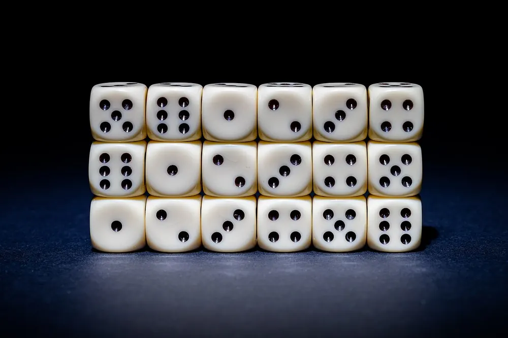 Rows of white dice on a dark surface, CS2 case odds in action