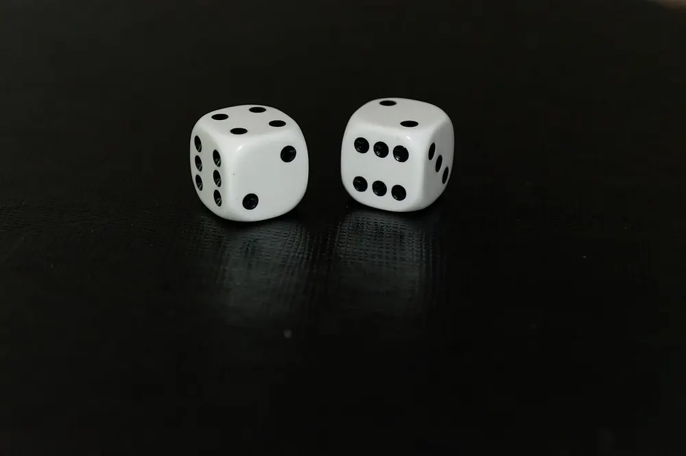 Two white dice on a black background, the luck in a CS2 case battle