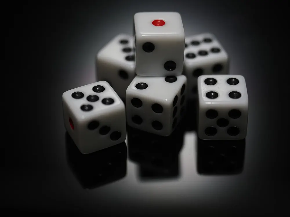 Stack of white dice under a spotlight