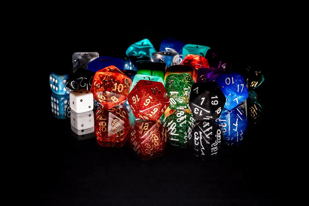 Pile of colorful polyhedral dice on a black background, CS2 gambling in the UK