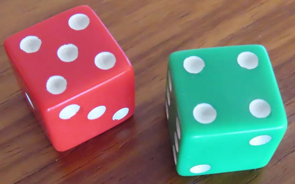 Red and green dice on a white background, the luck behind CSGOEmpire deposits