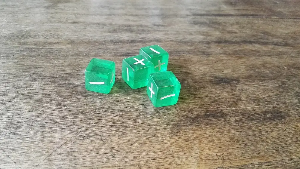 Green translucent dice on a wooden table