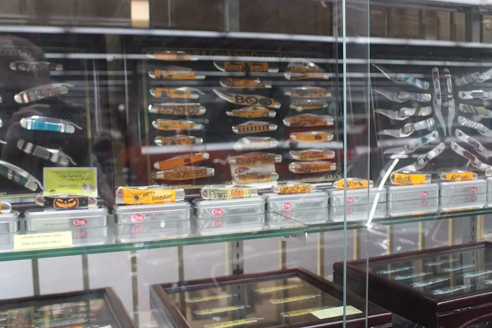 Display case of themed pocket knives, collectible like CS2 charms