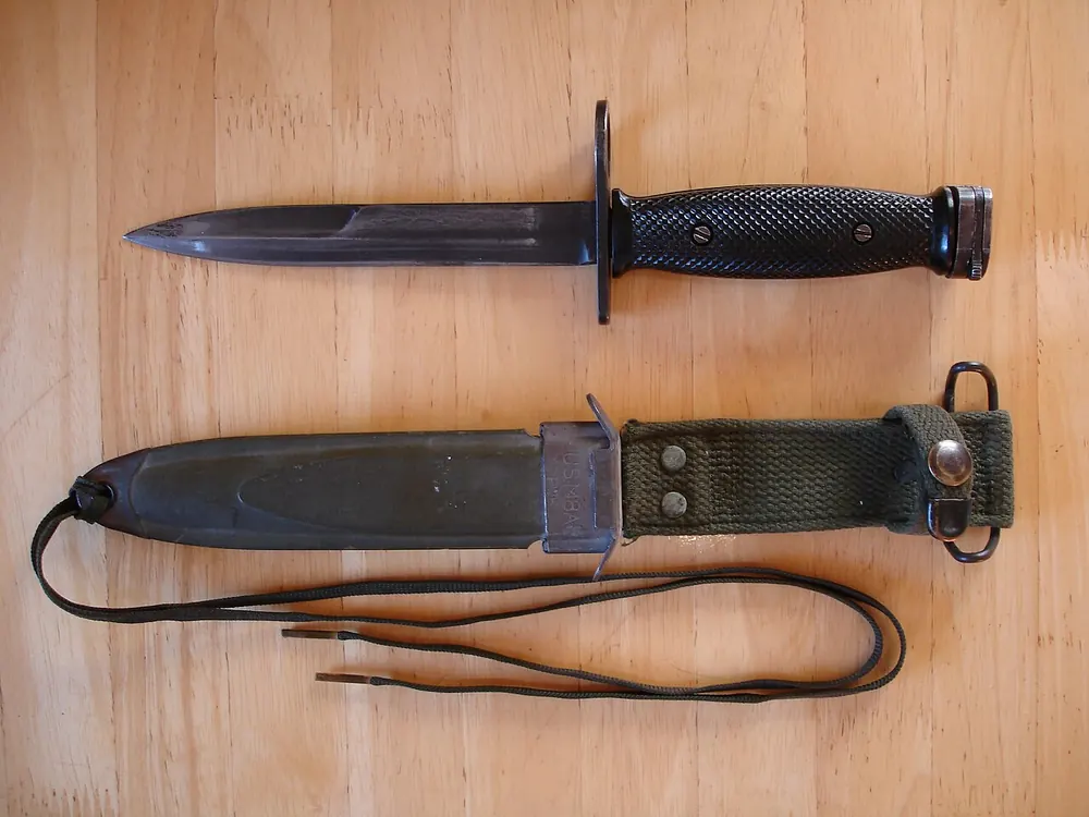 Combat knife with its leather sheath, checking a CS2 knife price