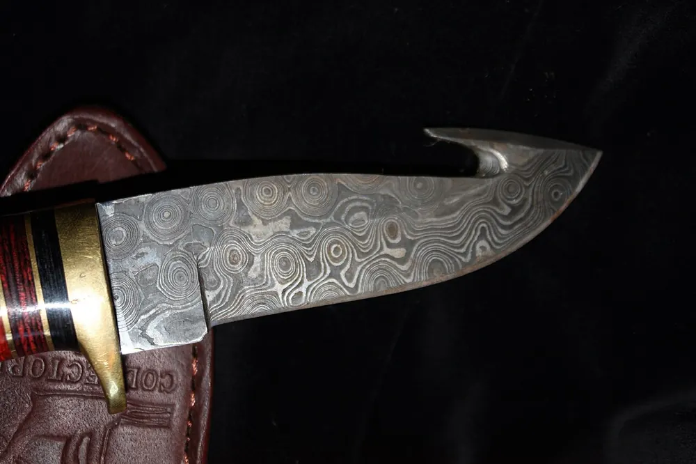 Damascus steel knife with a gut hook, the kind of skin people gamble CS2 items for
