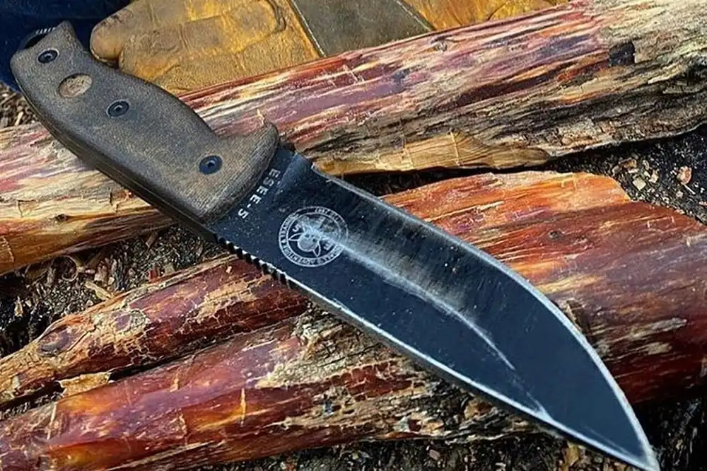 Tactical survival knife with a black blade and textured handle, a knife like you're hunting for in CS2