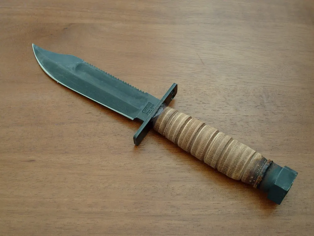 Survival knife with a stacked leather handle, the blade fade percentages show on