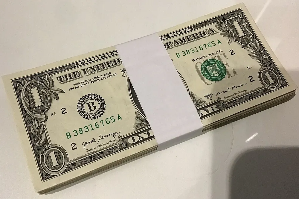 Bundle of one dollar bills held with a band