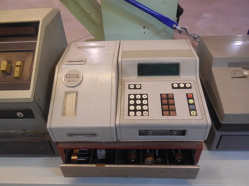 Vintage mechanical cash register in a museum, old-school deposits and withdrawals