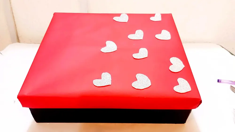 Red gift box decorated with hearts