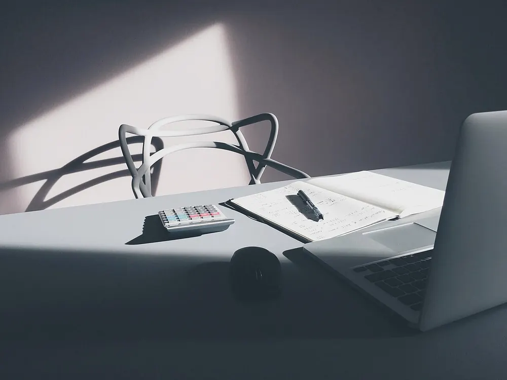 Desk with a laptop and a calculator, for running a CS2 case opening simulator